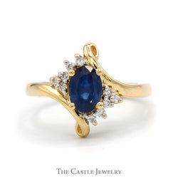 Oval Sapphire Ring With .05 CTTW of Diamonds in Bypass Design 14 KT Yellow Gold