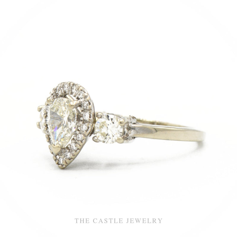 Side profile of the 14k white gold pear-halo diamond ring showing halo height and pavé shank