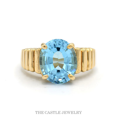 Oval Cut Blue Topaz Ring with Ridged Sides in 14k Yellow Gold