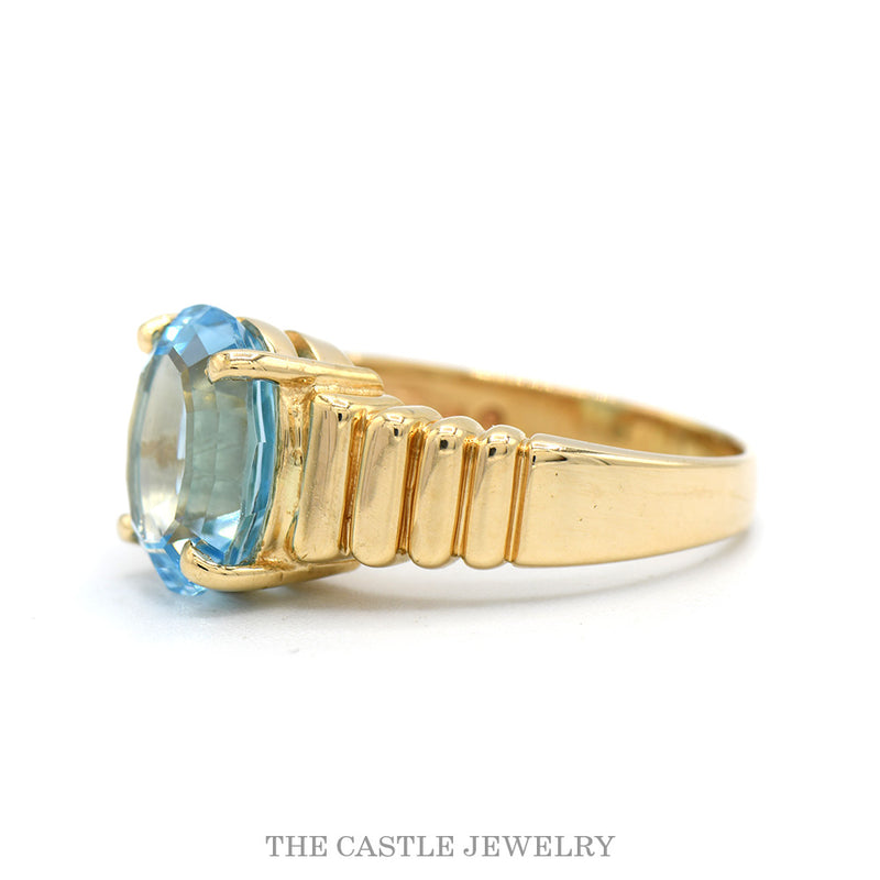 Oval Cut Blue Topaz Ring with Ridged Sides in 14k Yellow Gold