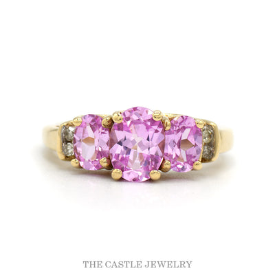 Three Stone Oval Cut Pink Topaz Ring with Diamond Accented Sides in 10k Yellow Gold
