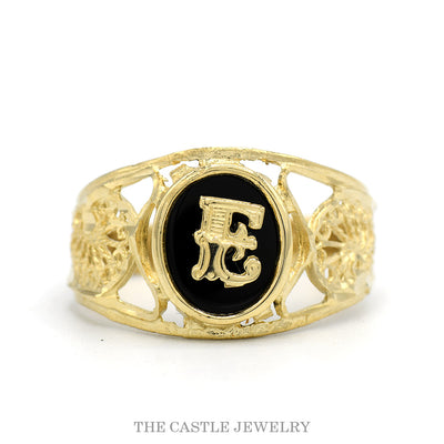 14k yellow gold men's initial ring with oval black onyx center and applied gold letter 'E' over filigree cut-out shoulders — top view