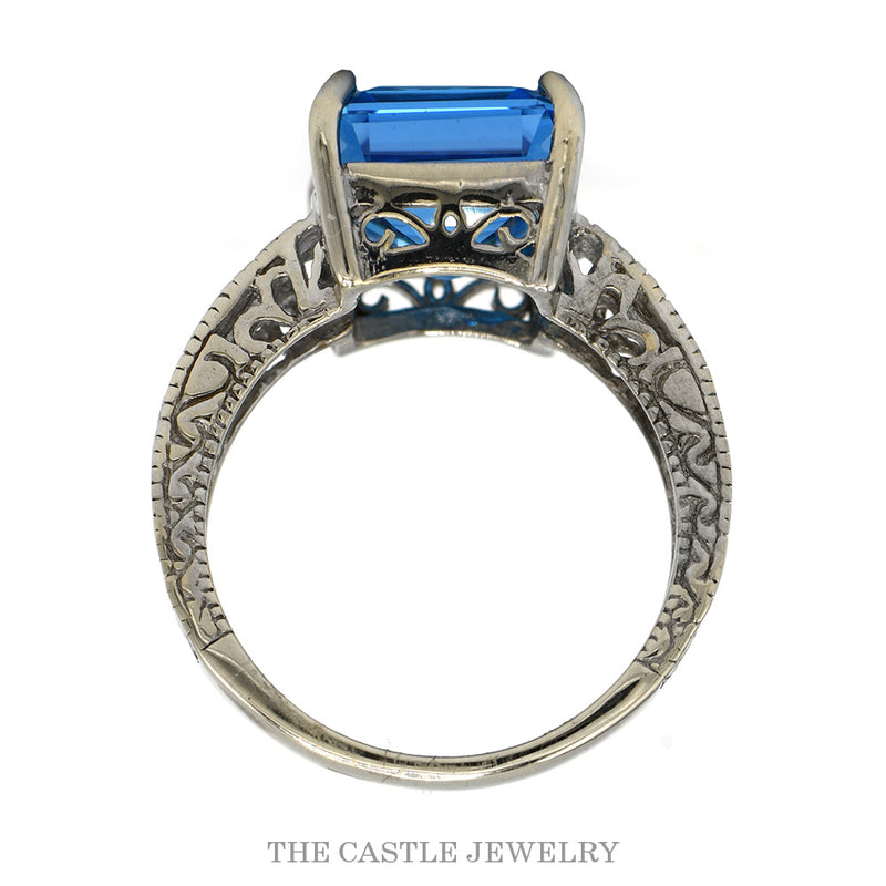 Front-facing view of the 14k white gold emerald cut blue topaz ring