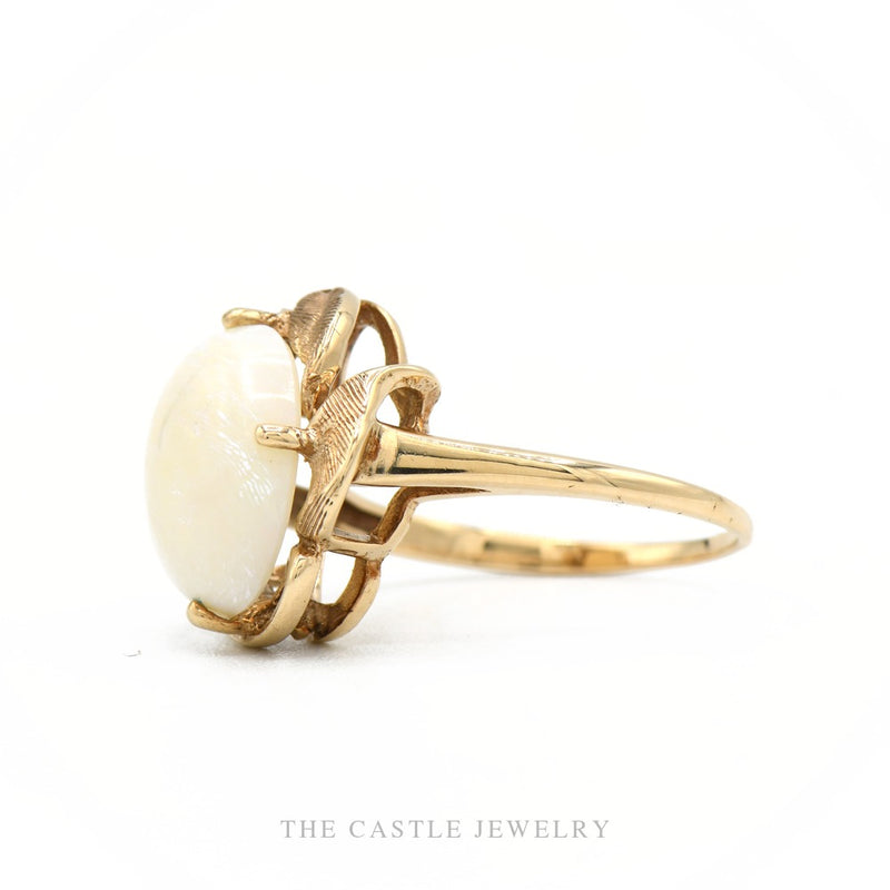 Side profile of the 10k yellow gold oval opal ring showing setting height and leaf mount