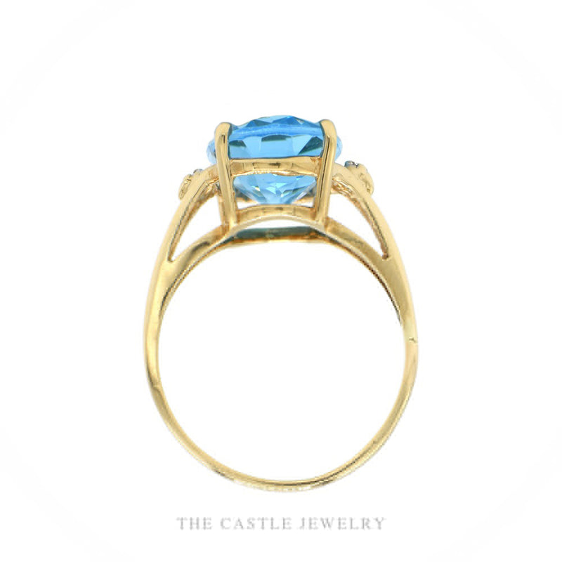 Front-facing view of the 10k yellow gold blue topaz ring showing illusion-set shoulder diamonds and split shank