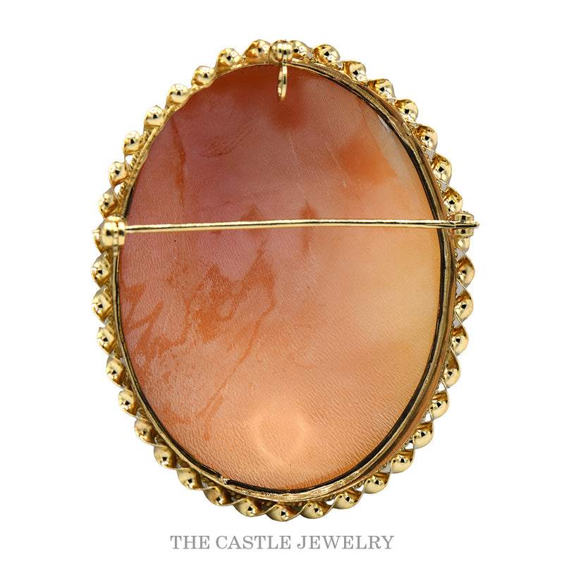 Reverse of the oval cameo pin showing the hinged stem, catch and looped ribbon border in 14k yellow gold