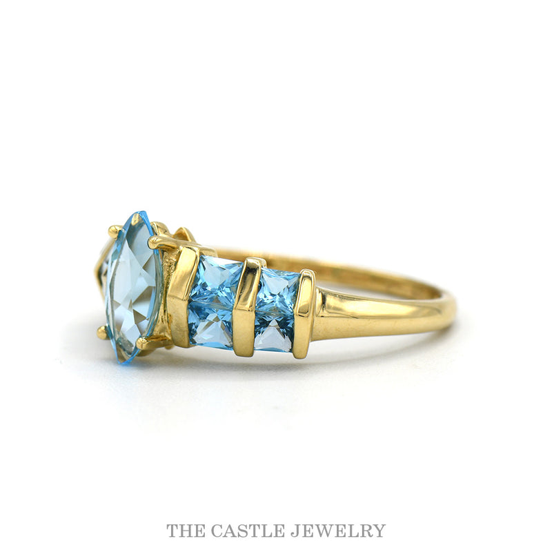 Side profile of the 14k yellow gold blue topaz row ring