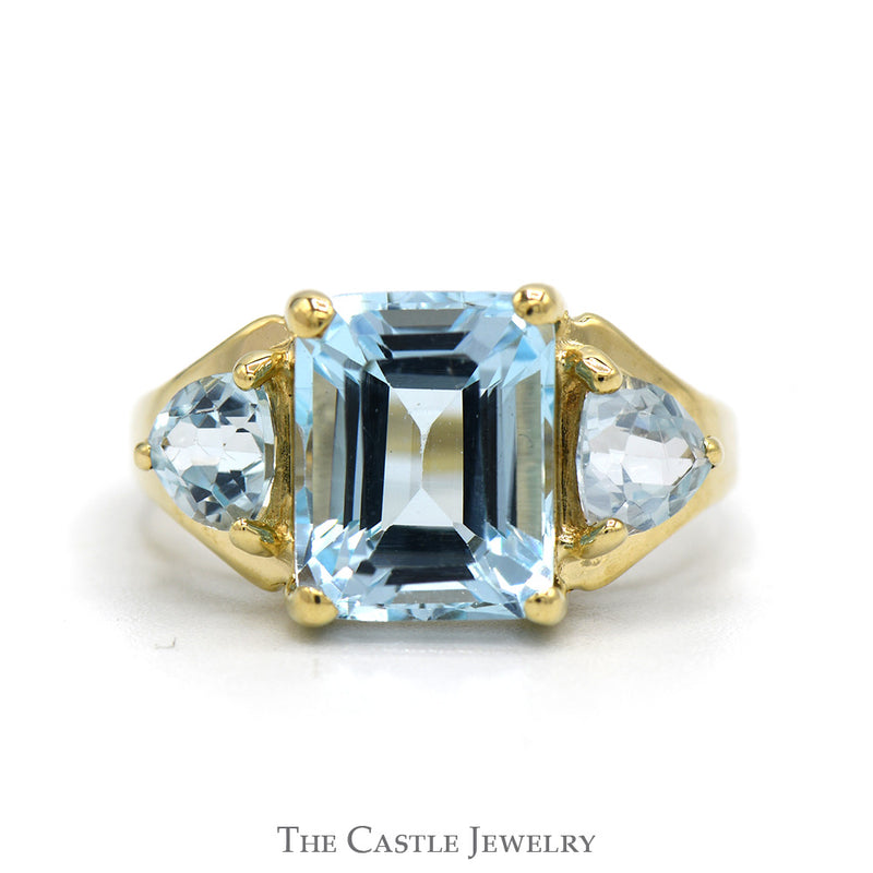 Emerald Cut Blue Topaz Ring with Trillion Cut Topaz Sides in 10k Yellow Gold