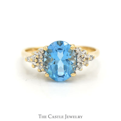 Oval Cut Blue Topaz Ring with Diamond Cluster Accented Sides in 14k Yellow Gold