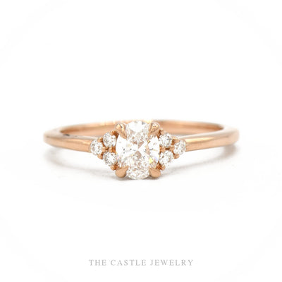 14k rose gold lab-grown oval diamond engagement ring with six-stone cluster shoulders — top view