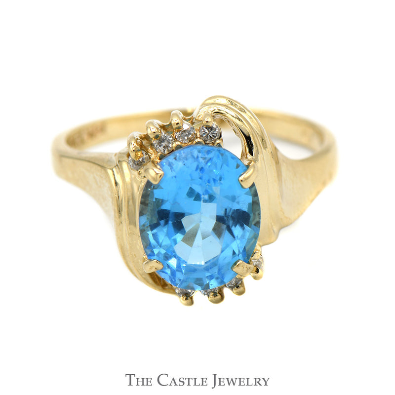 Oval Blue Topaz Ring with Diamond Accented Bypass Mounting in 14k Yellow Gold