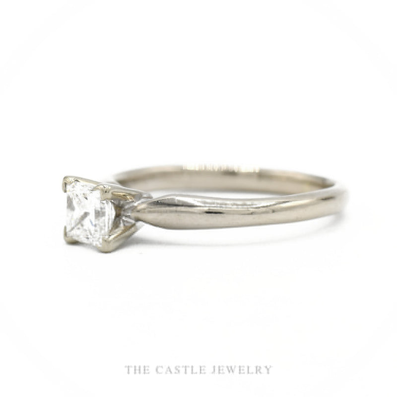Side profile of the 14k white gold princess-cut solitaire showing prong head height and tapered shank