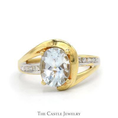 Oval Cut Aquamarine Ring with Channel Set Diamond Accented Sides in 10k Yellow Gold Swirled Bypass Mounting