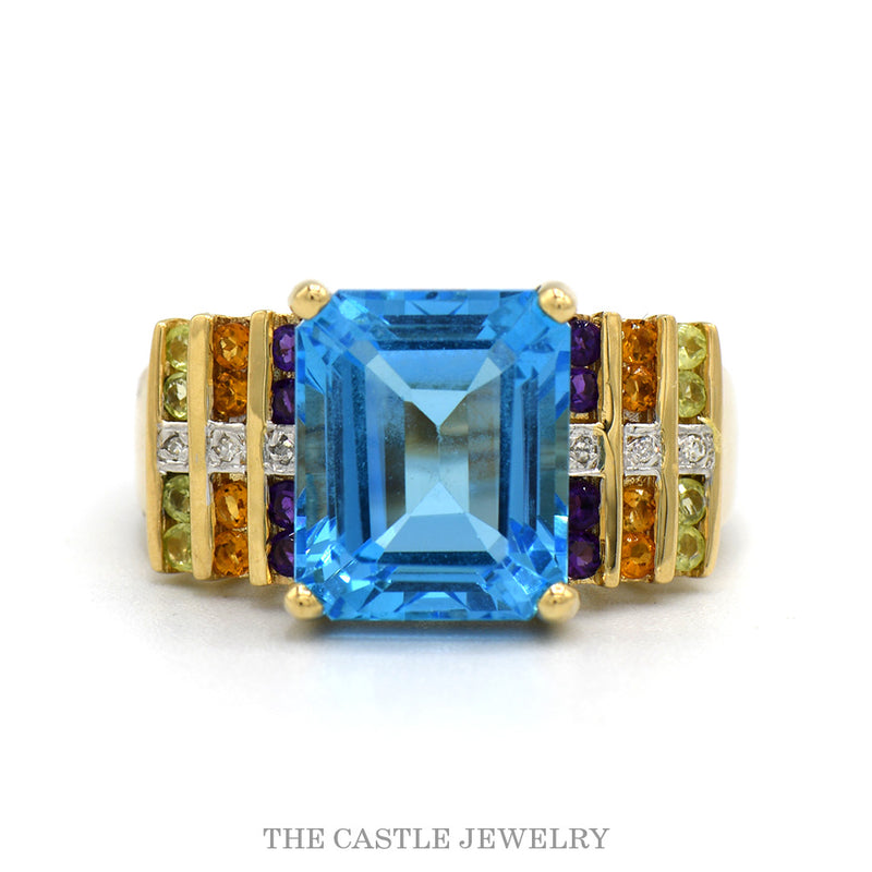 14k yellow gold emerald cut blue topaz ring with multi-gem sides — top view