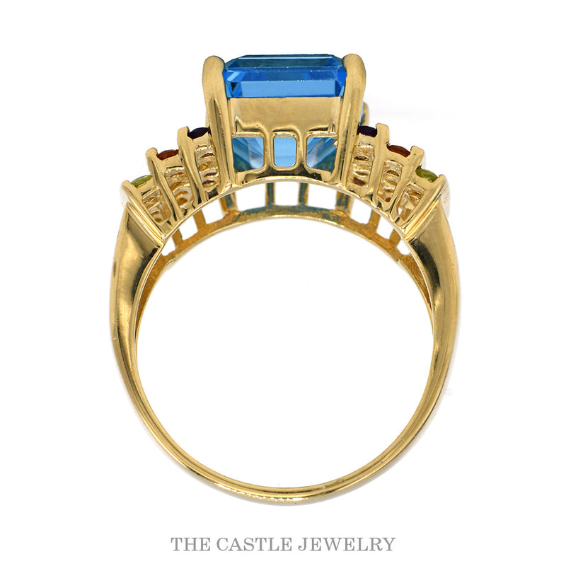 Front-facing view of the 14k yellow gold emerald cut blue topaz ring