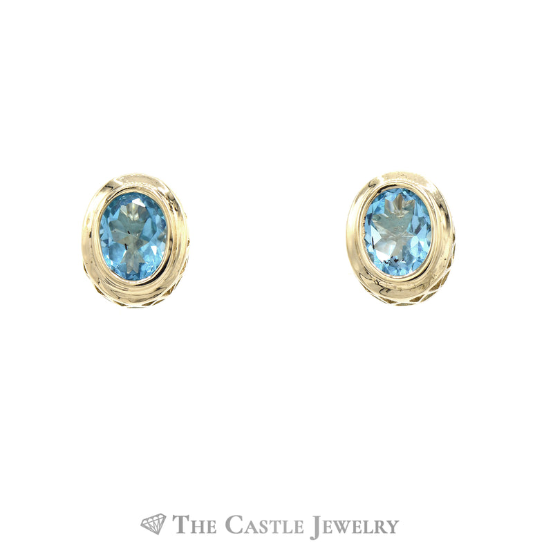 Oval Bezel Set Blue Topaz Earrings in 14k Yellow Gold