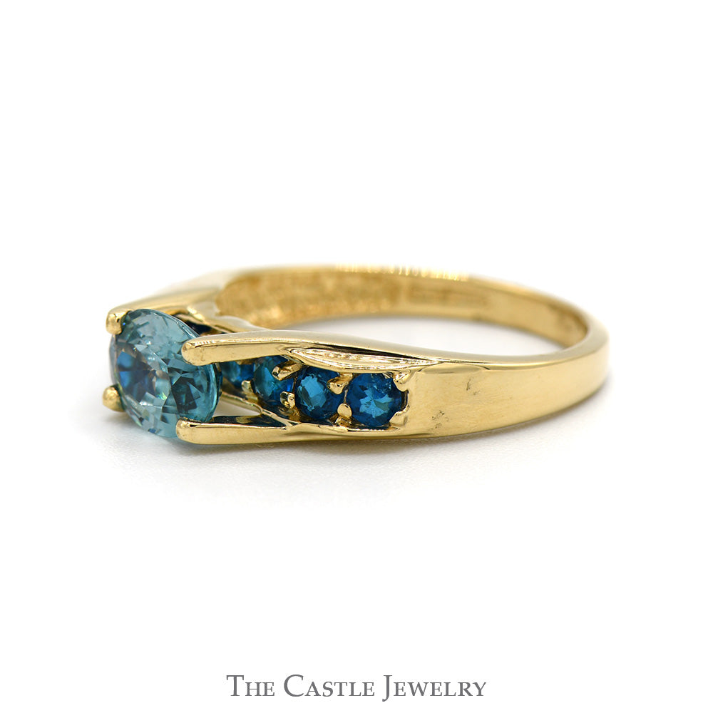 Oval Blue Zircon Ring with Blue Topaz Sides in 14k Yellow Gold Bridge Designed Mounting