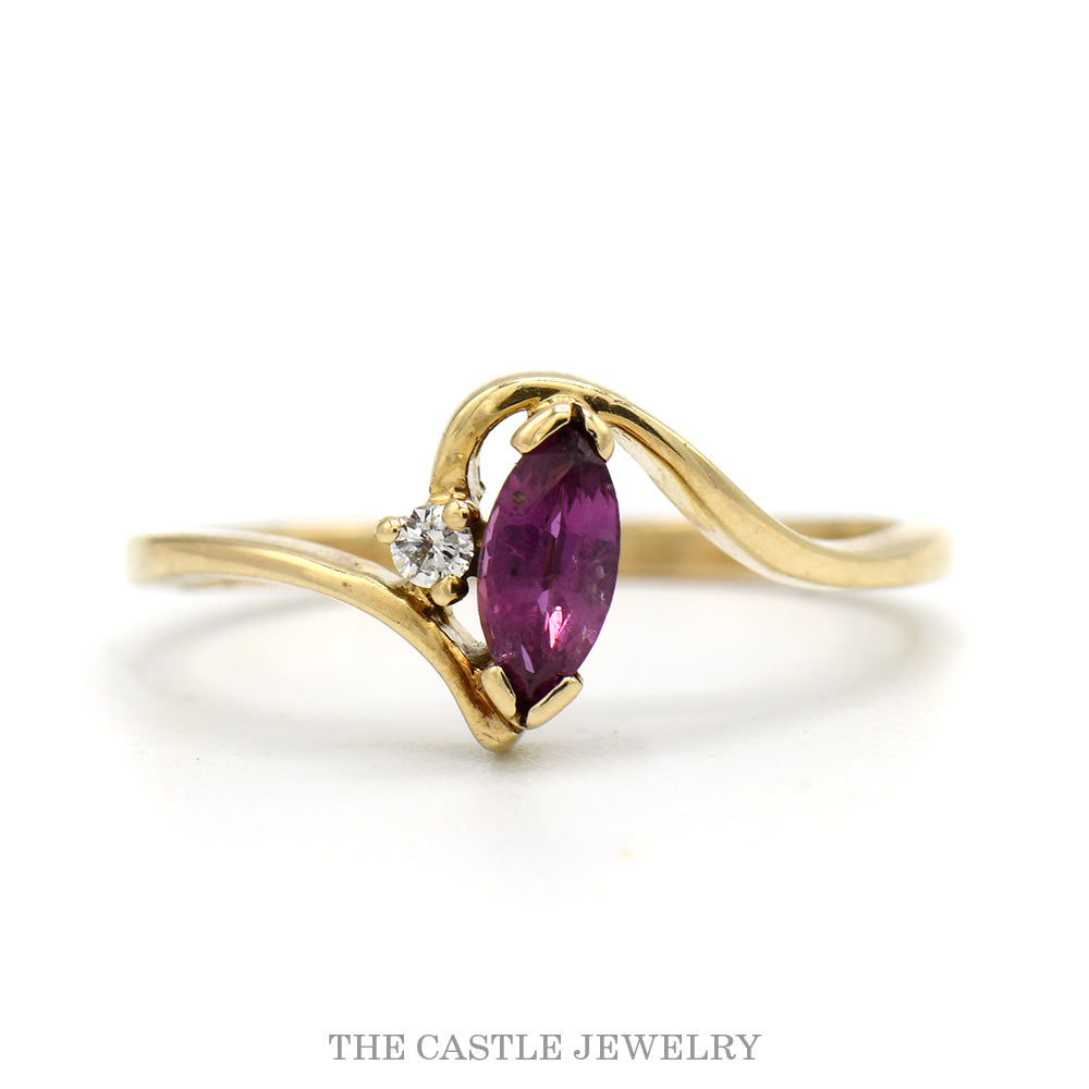 Marquise Ruby Solitaire Ring with Diamond Accent in 10k Yellow Gold Swirled Bypass Mounting