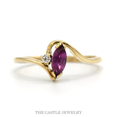 Marquise Ruby Solitaire Ring with Diamond Accent in 10k Yellow Gold Swirled Bypass Mounting