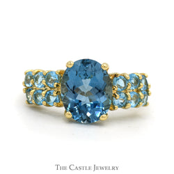 Oval Cut Blue Topaz Ring with Blue Topaz Cluster Sides in 14k Yellow Gold