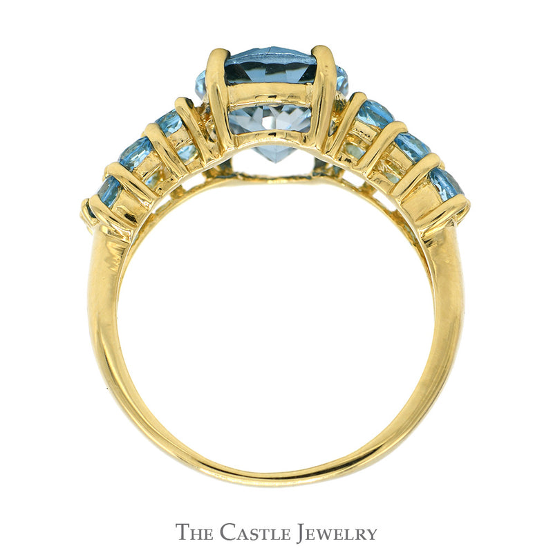 Oval Cut Blue Topaz Ring with Blue Topaz Cluster Sides in 14k Yellow Gold