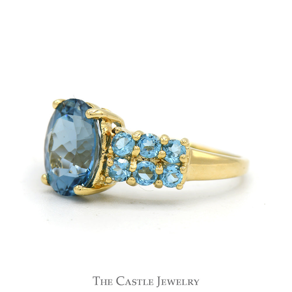 Oval Cut Blue Topaz Ring with Blue Topaz Cluster Sides in 14k Yellow Gold