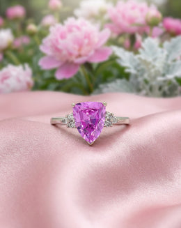 Trillion Synthetic Pink Sapphire Ring with Diamond Cluster Sides in 10k White Gold