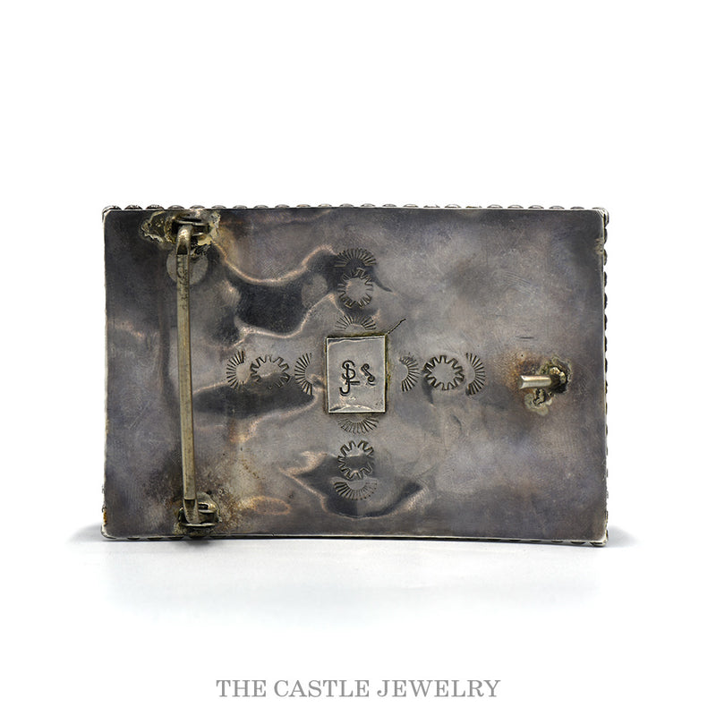 Reverse of the sterling bear belt buckle showing the belt bar, stamped sunbursts and the hallmark plaque