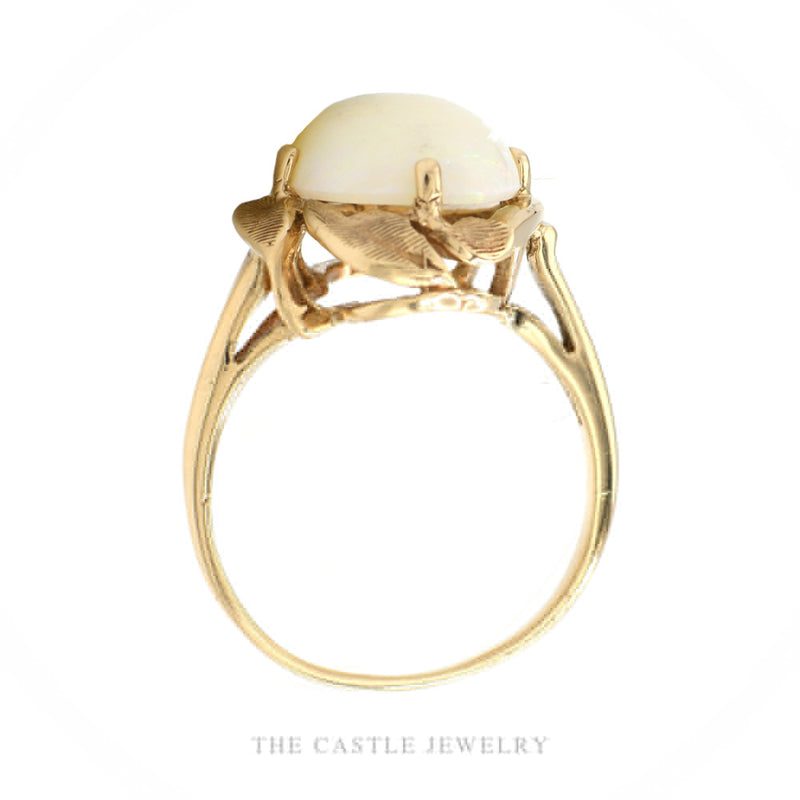 Front-facing view of the 10k yellow gold white opal ring showing leaf openwork detail around the stone
