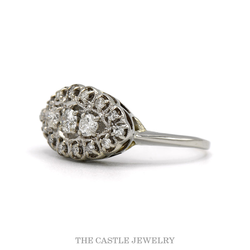 Side profile of the 14k white gold oval diamond cluster ring showing the domed openwork frame