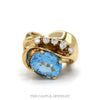 Oval blue topaz freeform bypass ring with a curved row of five round diamonds in 10k yellow gold — top view - Thumbnail 1