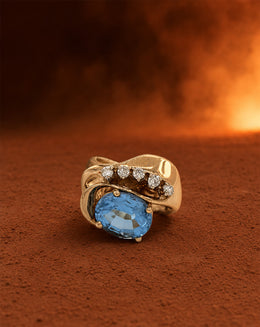 Oval Blue Topaz Freeform Bypass Ring with a Curved Row of Five Round Diamonds in 10k Yellow Gold