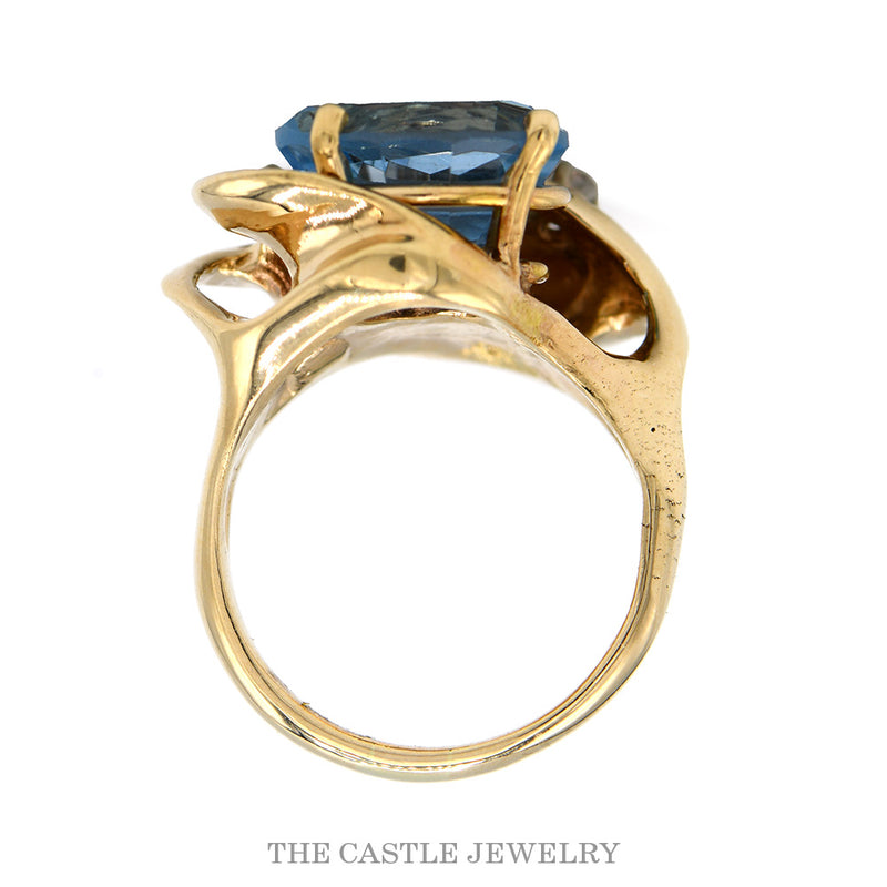 Front-facing view of the oval blue topaz ring with five diamonds in 10k yellow gold