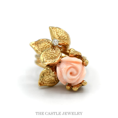 Carved coral rose ring with textured gold leaves and diamond accent in 14k yellow gold — top view
