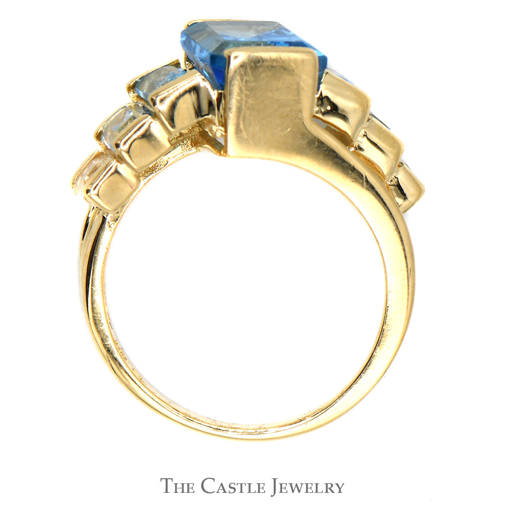 Emerald Cut Blue Topaz Ring with Graduated Design in 14k Yellow Gold Bypass Setting
