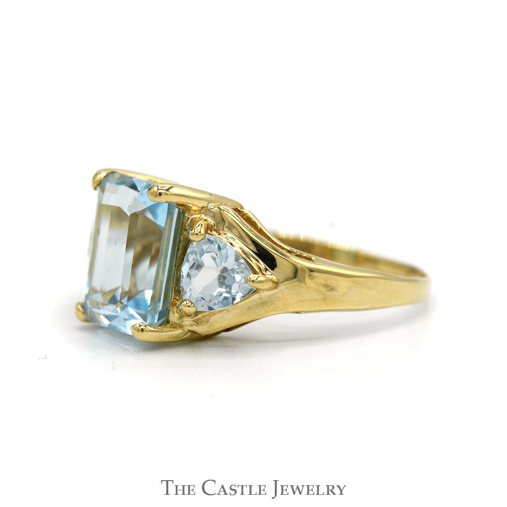 Emerald Cut Blue Topaz Ring with Trillion Cut Topaz Sides in 10k Yellow Gold