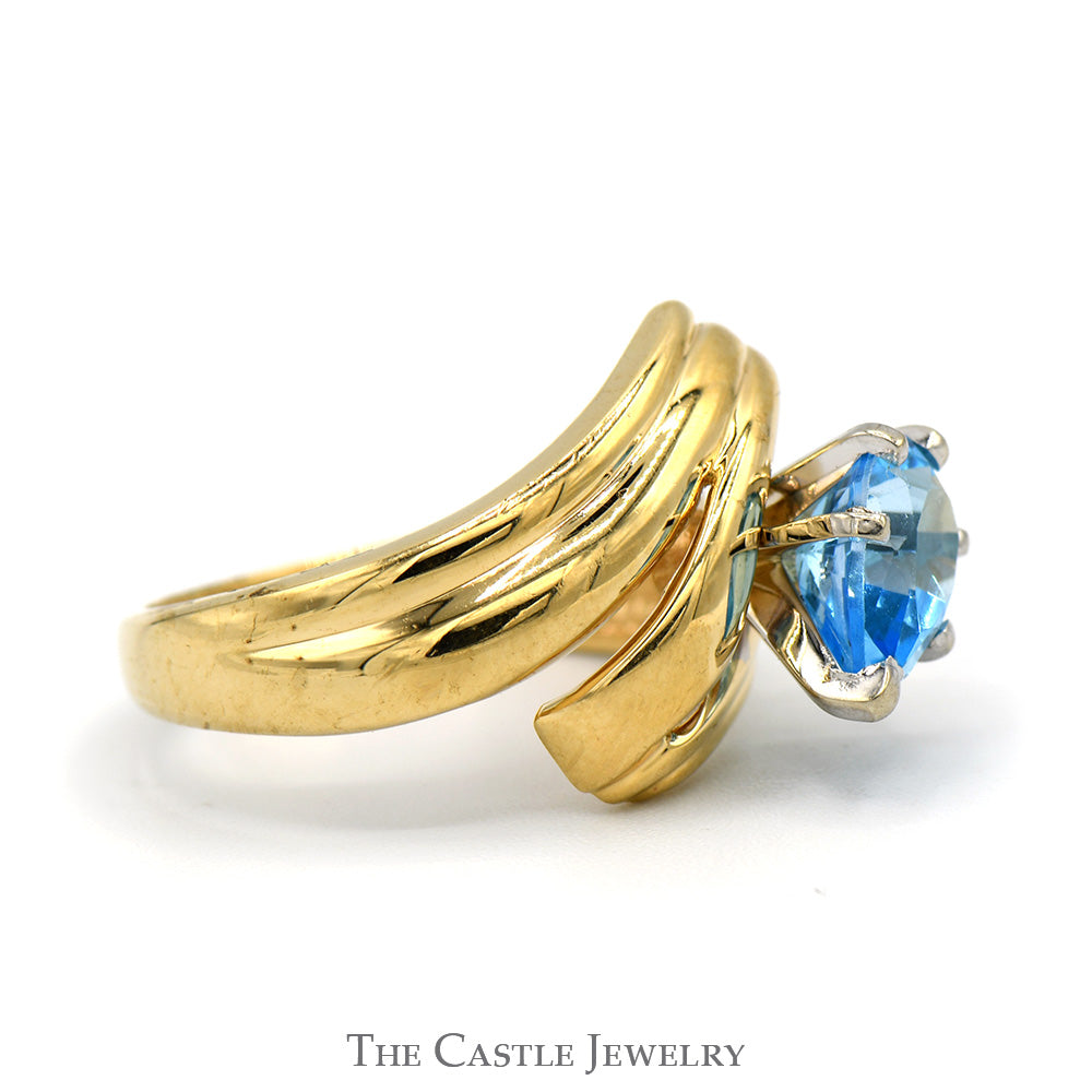 Pear Cut Blue Topaz Ring with Ridged Bypass Sides in 14k Yellow Gold