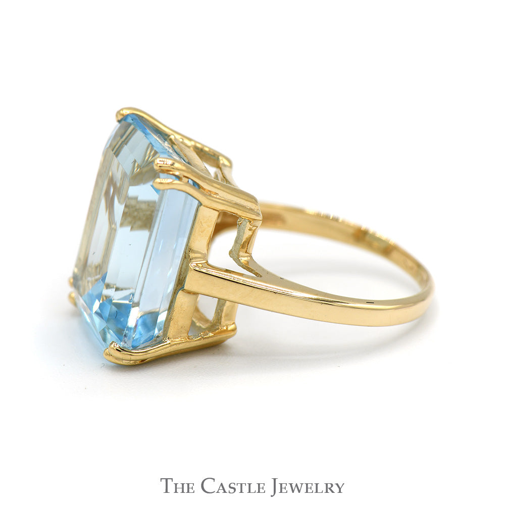 Emerald Cut Blue Topaz Ring in 10k Yellow Gold Cathedral Mounting