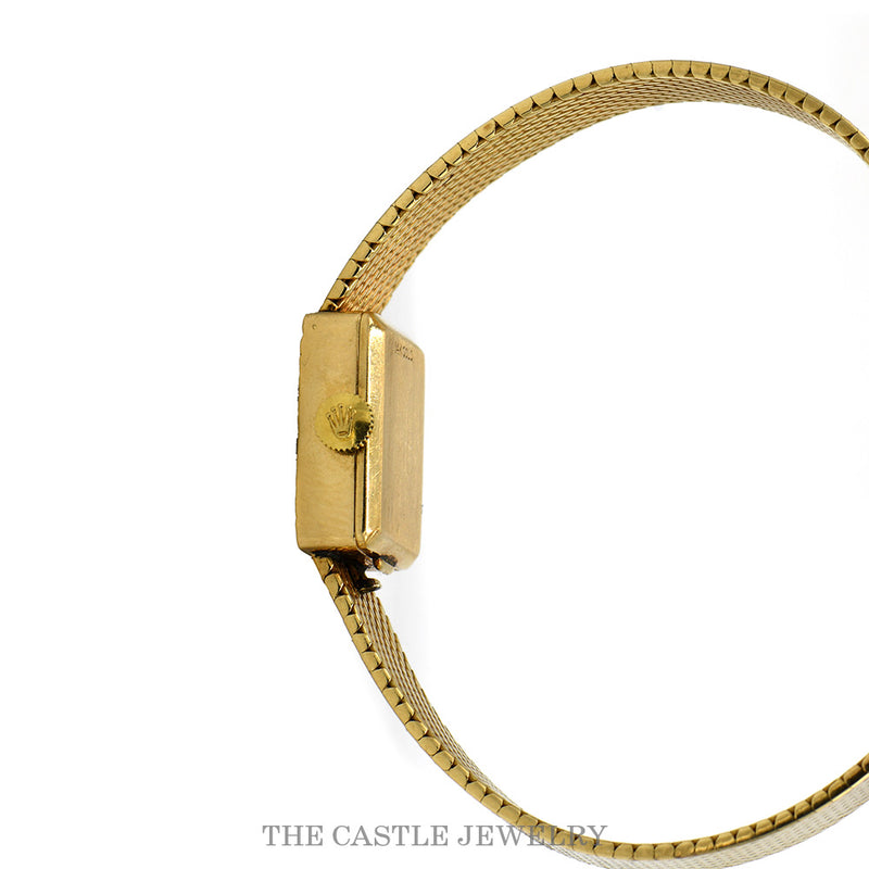 Side view of the rectangular 14k gold case with the Rolex-signed winding crown at twelve
