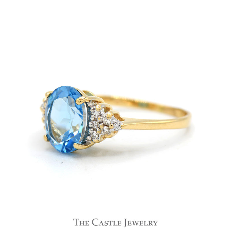 Oval Cut Blue Topaz Ring with Diamond Cluster Accented Sides in 14k Yellow Gold