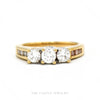 18k yellow gold three-stone round diamond ring with channel-set diamond shoulders — top view - Thumbnail 1