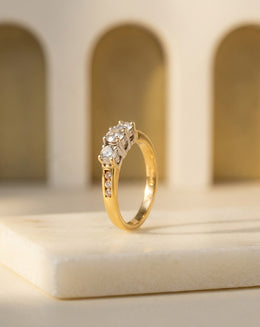 1.00ctw Three-Stone Round Diamond Ring with Channel-Set Diamond Shoulders in 18k Yellow Gold