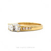 Side profile of the 18k yellow gold three-stone diamond ring showing setting height and channel shoulders - Thumbnail 3
