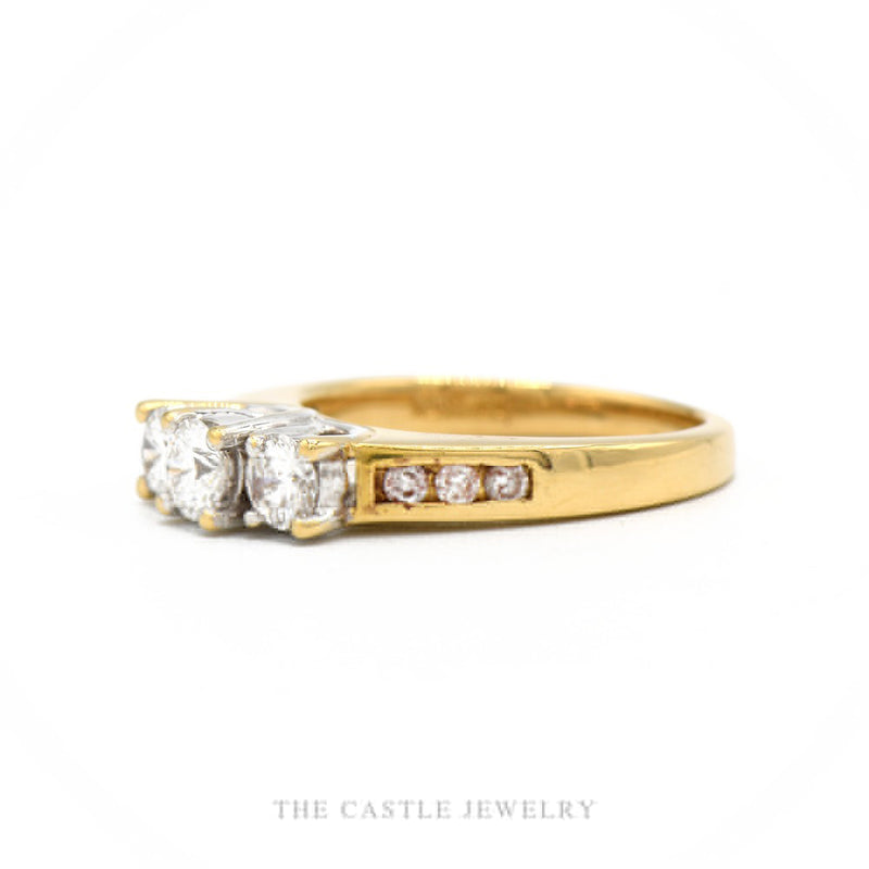 Side profile of the 18k yellow gold three-stone diamond ring showing setting height and channel shoulders