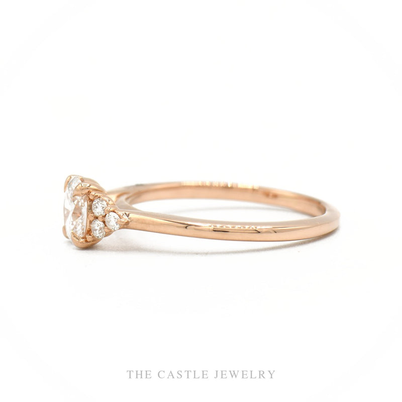 Side profile of the 14k rose gold lab-grown oval diamond ring showing setting height and cluster shoulders