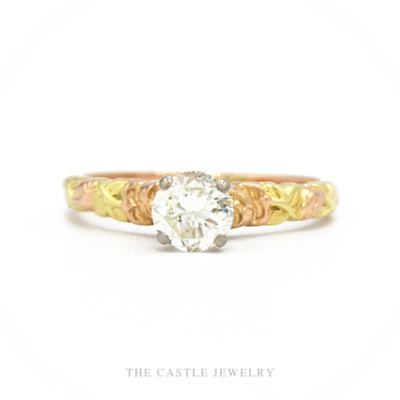 14k tri-color gold engagement ring with 0.60ct round brilliant diamond solitaire and carved leaf shank — top view