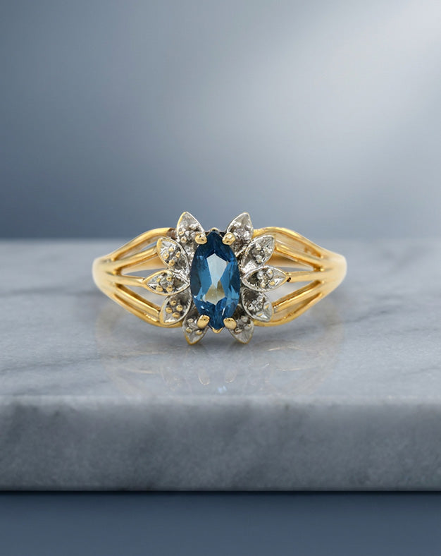 Marquise Blue Topaz Ring with 0.05ctw Diamond Accents in 14k Yellow Gold — lifestyle photography