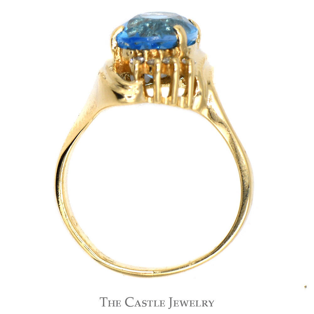 Oval Blue Topaz Ring with Diamond Accented Bypass Mounting in 14k Yellow Gold