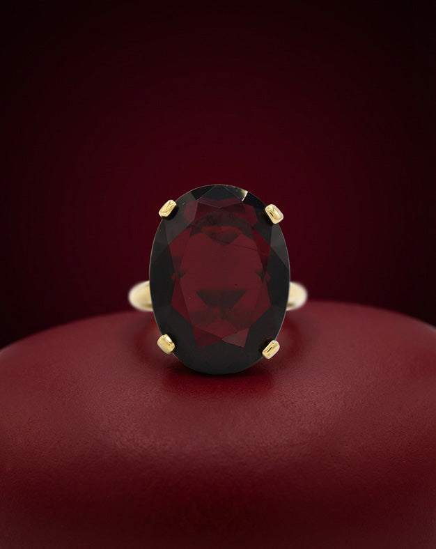 Large Oval Cut Garnet Solitaire Ring in 14k Yellow Gold — lifestyle photography